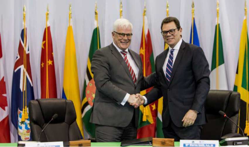 Image: EIB Vice President, Pim Van Ballekom (left) and CDB President, Dr. William Warren Smith (right) shake hands after signing the agreement for the Climate Action Framework Loan II on Wednesday in Providenciales, Turks and Caicos Islands.