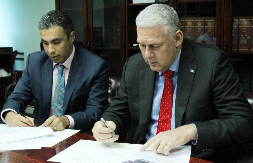 Image: Prime Minister Allen Chastanet and Mohammed Asaria signing the definitive agreement. [PHOTO: PhotoMike]