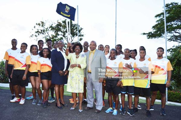 Image: Governor General Dame PearletteLouisy holds the QBR aloft. Also in photo are Acting Prime Minister Ezechiel Joseph, Regional Vice President of the Commonwealth Games, Fortuna Belrose, and participating athletes. (Photo: Anthony De Beauville)