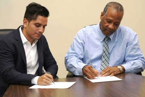 iMAGE: LUCELEC’s Managing Director, Trevor Louisy, and a GRUPOTEC representative at the contract signing ceremony.
