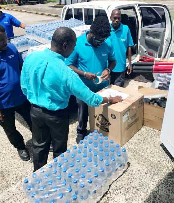Image: Saint Lucia Country Manager Chris Williams helps pack supplies for Dominica.