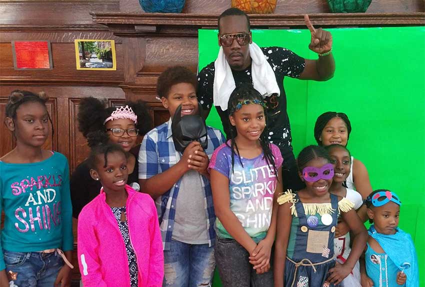 Image: Mac 11 and the children during a photo op at the event.