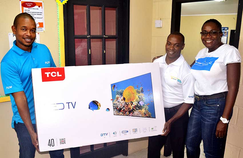 Image: Flow customer Fleming Jn. Paul (centre) won himself a brand new TCL TV!