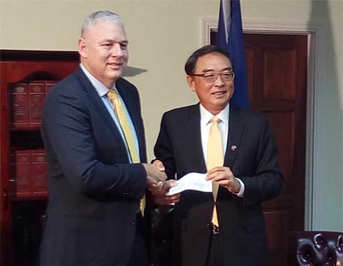 Image: P.M. Chastanet and Ambassador Shen at Thursday’s cheque handing-over ceremony. (PhotoMike)