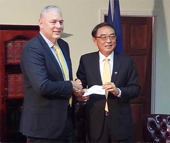 Image: P.M. Chastanet and Ambassador Shen at Thursday’s cheque handing-over ceremony. (PhotoMike)