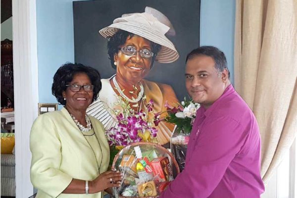 Image of Regional Public Relations Manager, Sunil Ramdeen, presenting tokens to Dame Pearlette Louisy.