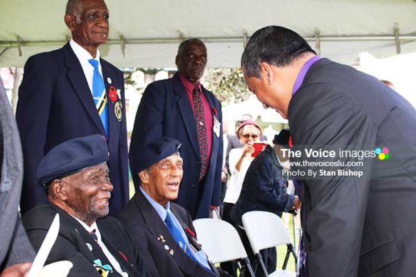 Image of Acting Prime Minister, Guy Joseph, greeting veterans and others at the ceremony.