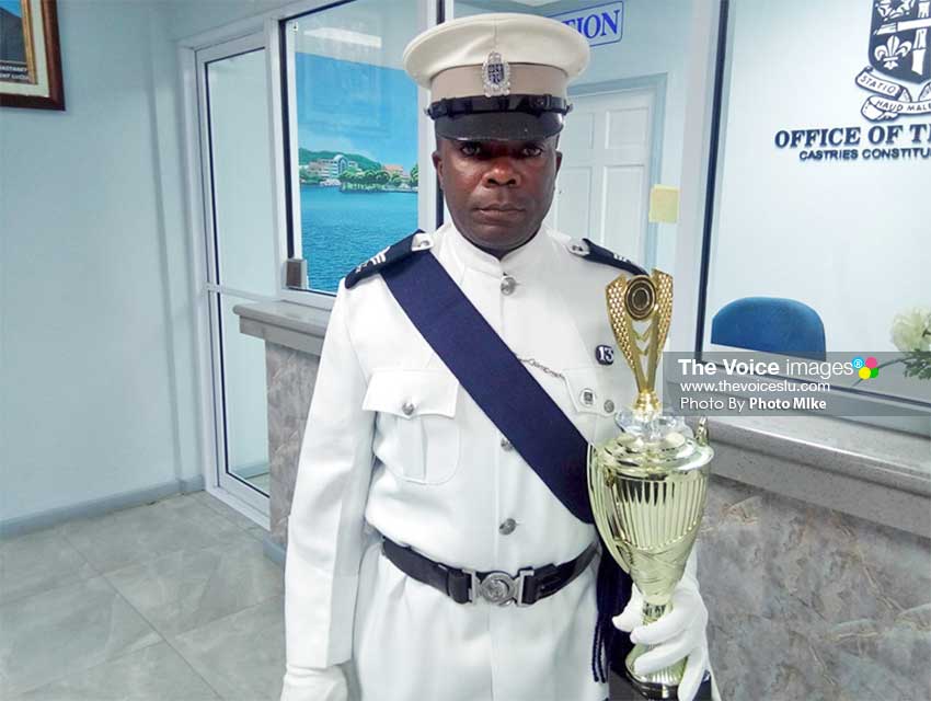 Image of Aubrey St. Juste of the Constabulary with his trophy for winning the Employee of the Year Award. (PhotoMIke)
