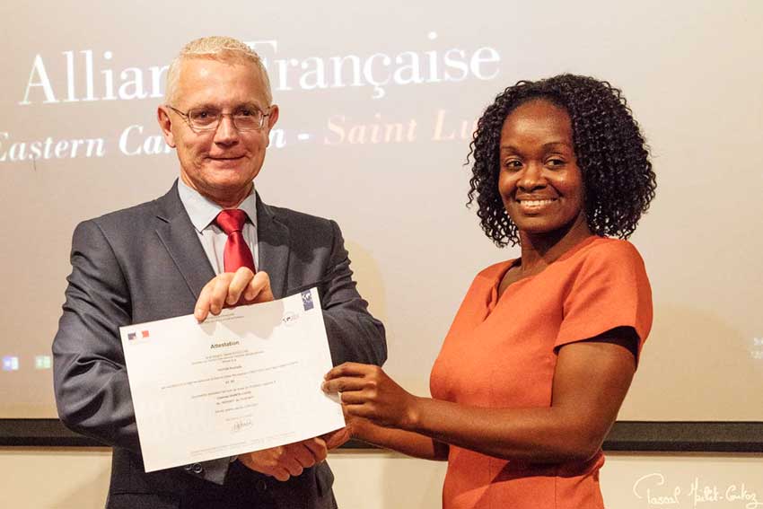 Image: Philippe Ardanaz, French Ambassador in Saint Lucia, presents a certificate to one of the course participants (right).