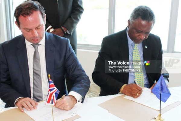 Image: Resident British Commissioner Steve Cready and Home Affairs and National Security Minister Hermangild Francis signing MOU yesterday. [ PHOTO: PHOTOMIKE]