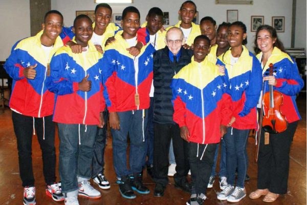 Image: Young Saint Lucian performers with the Venezuelan master musician Jose Antonio Abreu, during one of several encounters.