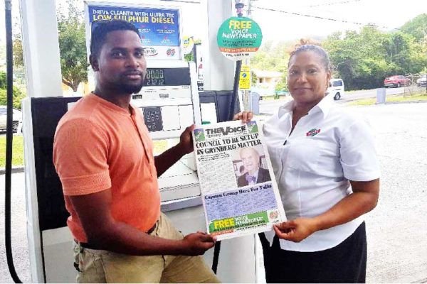 Image: (L-R) A proud Rubis customer collects the VOICE Newspaper from a Rubis representative. (PHOTO:Rubis Saint Lucia)