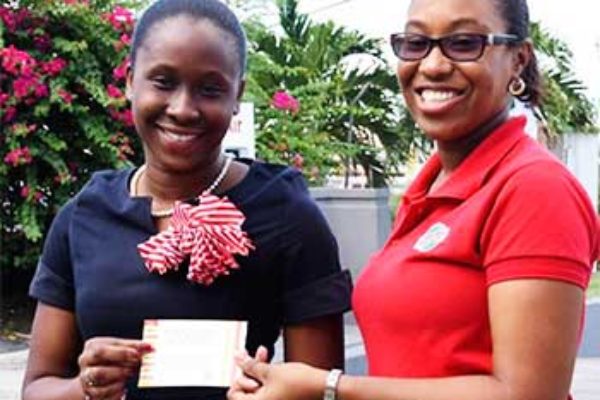 Image: (L-R) DarnicaJn Charles receiving her Jazz tickets from RUBIS West Indies Limited’s, ChriseldaNorbal, Assistant Account Executive. (PHOTO: RUBIS)