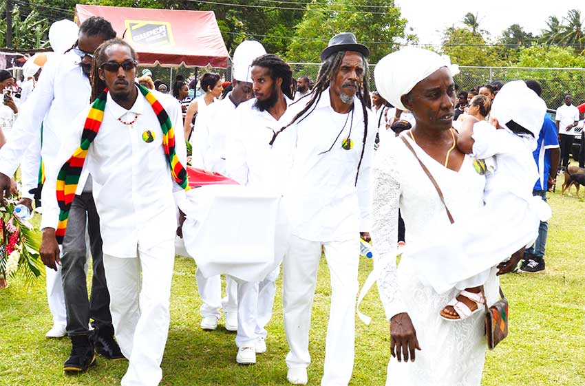 Image: Tafari’s mother Marilyn Martin Charlemange leads the cortege onto the field; Tafari’s coffin in open air at the LCPF (Photo: Anthony De Beauville)