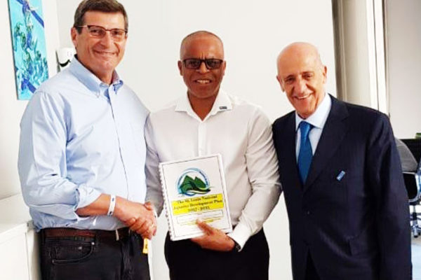 Image of Eddie Hazell presenting Saint Lucia’s Five Year Aquatic Development Plan to FINA’s President at the opening of the new FINA headquarters. (PHOTO: SLASA)