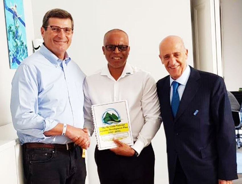 Image of Eddie Hazell presenting Saint Lucia’s Five Year Aquatic Development Plan to FINA’s President at the opening of the new FINA headquarters. (PHOTO: SLASA)