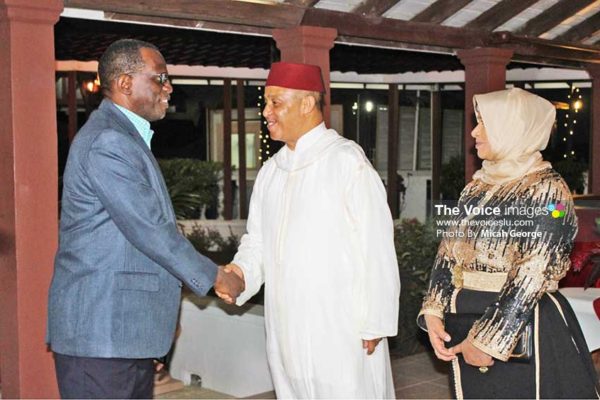 Image of Ambassador Abderrahim greeting Opposition Leader Philip J Pierre Monday night at the reception; Next to the Ambassador is his wife.