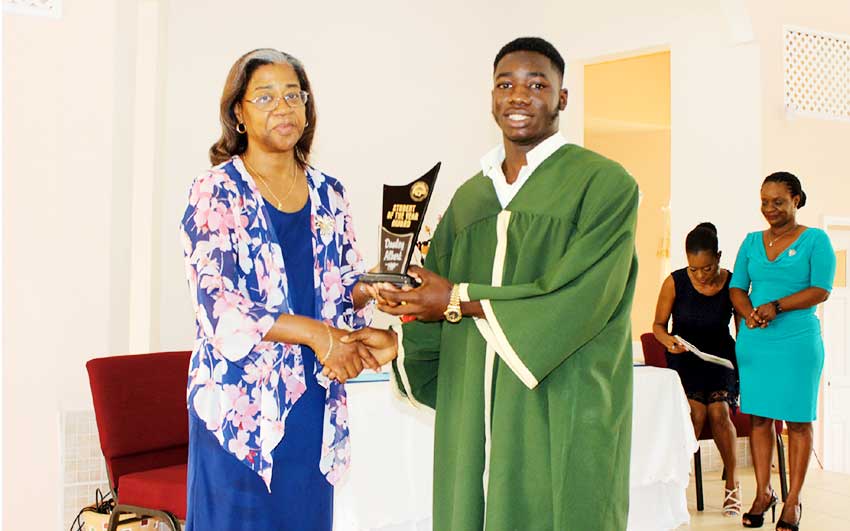 Image of Health Minister Mary Isaac congratulating the winning student.