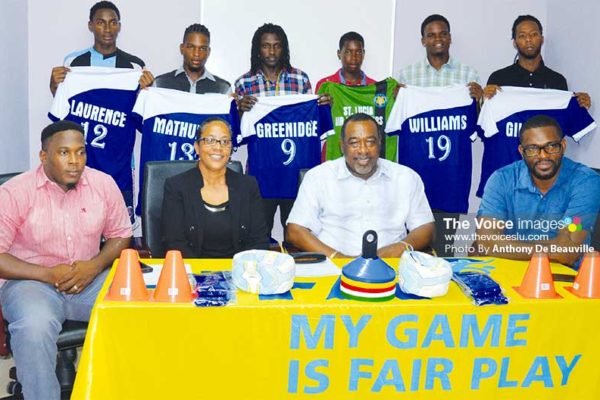 Image: (BACK ROW) - members of the Gros Islet football team displaying their new playing top; (FRONT ROW L-R) Shayne Paul - President GIFL, Francillia Scott - CEO Saint Lucia Air Freighters, Larry Scott - CEO Scotts Sports Shops and Awards, Charde Desir - 1st Vice President GIFL. (PHOTO: Anthony De Beauville)