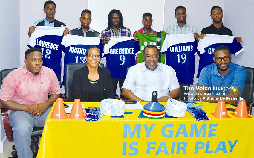 Image: (BACK ROW) - members of the Gros Islet football team displaying their new playing top; (FRONT ROW L-R) Shayne Paul - President GIFL, Francillia Scott - CEO Saint Lucia Air Freighters, Larry Scott - CEO Scotts Sports Shops and Awards, Charde Desir - 1st Vice President GIFL. (PHOTO: Anthony De Beauville)