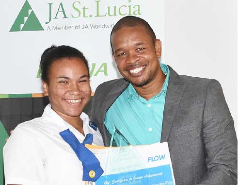 Image: 1st place National Achiever of the year goes to ZennaHadeed of the Corinth Secondary School who also got a handset compliments FLOW from Flow Communications Specialist Terry Corwin Finnisterre.
