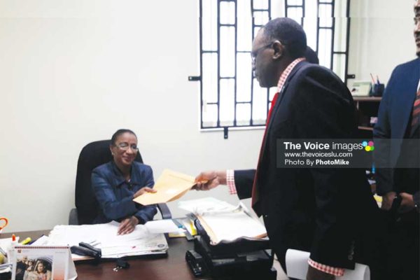 Image of Opposition Leader Philip J. Pierre submitting the draft motion to the Clerk of Parliament on Tuesday. (PHOTO: PhotoMike)