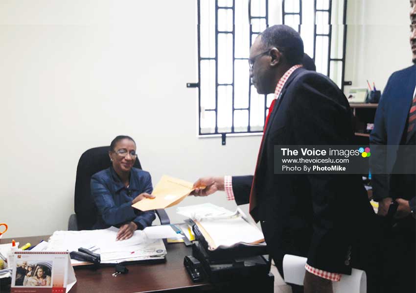 Image of Opposition Leader Philip J. Pierre submitting the draft motion to the Clerk of Parliament on Tuesday. (PHOTO: PhotoMike)