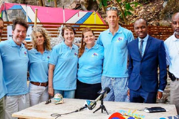 Image: (L-R) Weston Moses, Paul Nance, Lily Bergasse, Molly Nance (the eventual swimmer), Sue Dyson, Nathaniel Waring, Tourism Minister - Dominic Fedee and Director of Sports in the Department of Youth Development and Sports - Patrick Mathurin (Photo: SLCS)