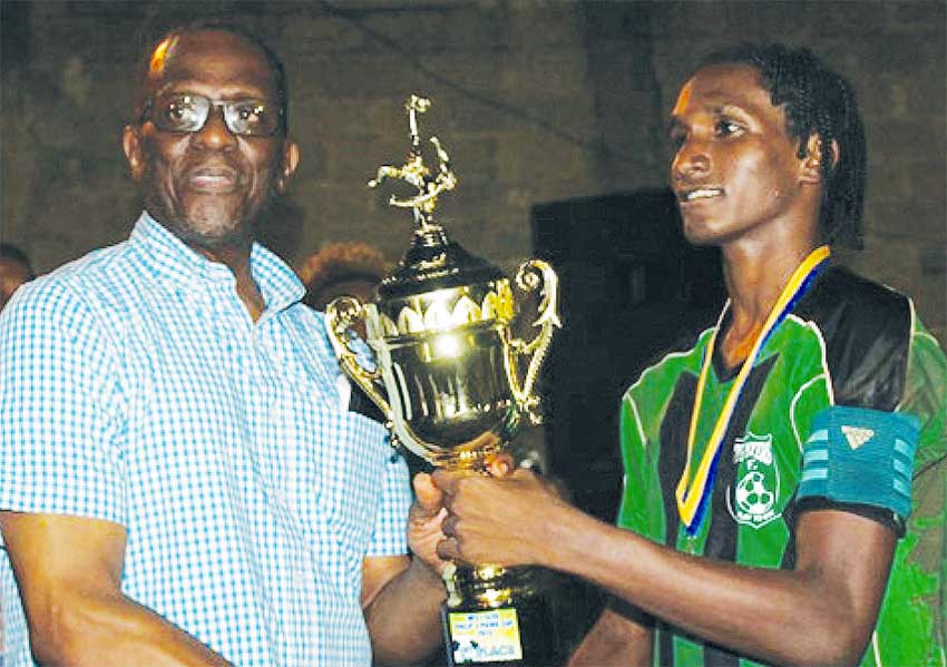 Image: (L-R) Parliamentary representative for Castries East, Phillip J Pierre presenting the championship trophy to Big Players Youth captain Shermon St. Ange (PHOTO: MFL)