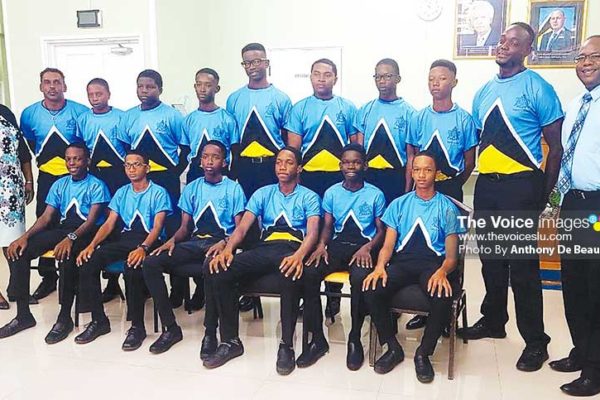 Image: A picture moment for a confident Saint Lucia Under -15 cricketers, Deputy Permanent Secretary in the Department of Youth Development and Sports Liota Charlemange - Mason and 1st National Bank representative Robert Fevrier. (PHOTO: Anthony De Beauville)