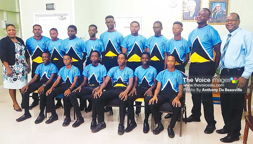 Image: A picture moment for a confident Saint Lucia Under -15 cricketers, Deputy Permanent Secretary in the Department of Youth Development and Sports Liota Charlemange - Mason and 1st National Bank representative Robert Fevrier. (PHOTO: Anthony De Beauville)