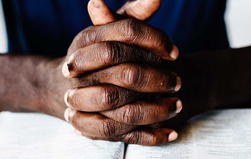 Image of hands clasped in prayer