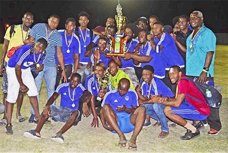Image: (L-R) Saint Lucia representative team, Platinum; Platinum captain, Dwayne Charles receiving the 2018 championship trophy from SLFA President, Lyndon Cooper. (PHOTO: Anthony De Beauville)