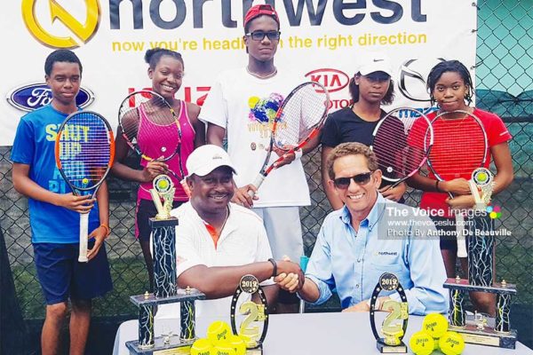 Image: (Back row) Some of the players taking part in the tournament; (front row – L-R)SirseanArlain and Larry Bain, the hand shake signifies a long haul between Tiger Tennis Academy and Northwest Limited. (PHOTO: Anthony De Beauville)