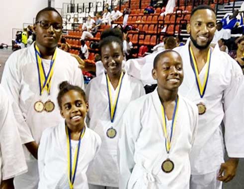 Image: (L-R) Medal winners; Team Saint Lucia on the opening day of the championship. (PHOTO: UT)