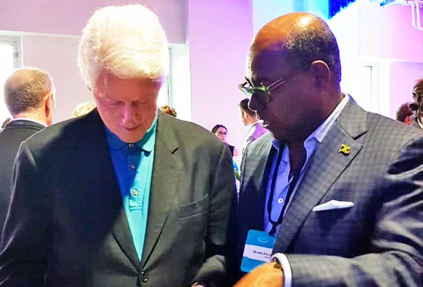 Image of Jamaica’s Tourism Minister Ed Bartlett speaking with former US President Bill Clinton at the Clinton Global Imitative in the USVI.