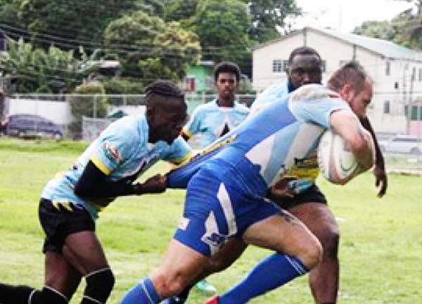 Image: Saint Lucia’s Yohan Henry tries to stop Diamante’s Julien Estaques from scoring; Elvin Joseph catching the ball to launch an attack. (PHOTO: SLRFU)