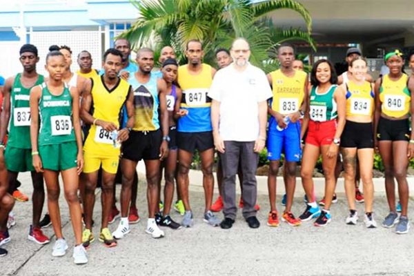 A photo moment for Caricom Secretary-General Ambassador Irwin LaRocque and race participants on Sunday. (PHOTO: NM)