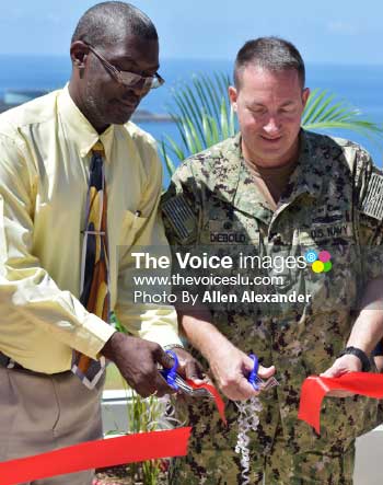 Image of ribbon cutting ceremony for the opening of the USNS Comfort humanitarian effort. Felix St Hill (left) Brian Diebold (right). [Photo: Allen Alexander] 