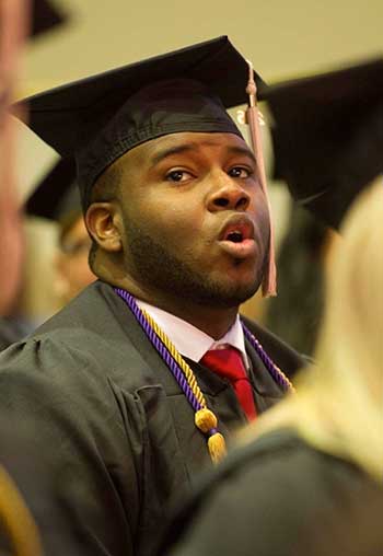 Image of Botham Jean singing lustily during his graduation ceremony 