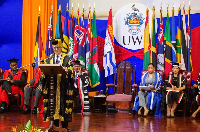 Image: Chancellor Robert Bermudez addressing the company as members of the UWI Executive on the platform look on.