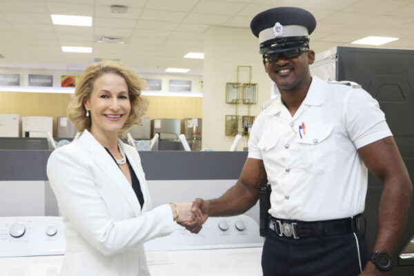 Image: Make It Happen’s Raquel DuboulayChastanet makes donations of washing machines to various police stations island-wide.