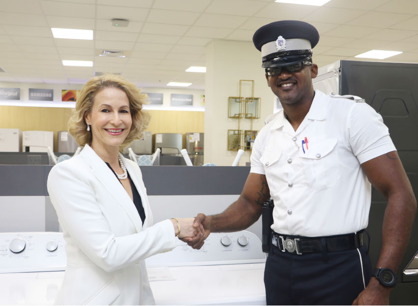 Image: Make It Happen’s Raquel DuboulayChastanet makes donations of washing machines to various police stations island-wide.