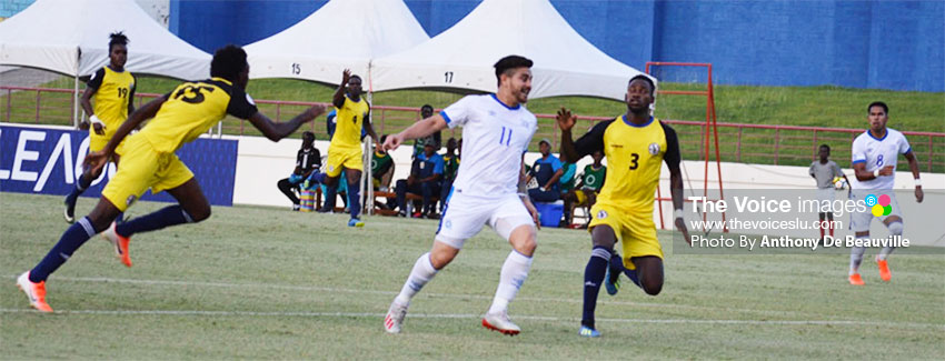 Image: El Salvador No. 11 Rodolfo Zelaya on the counter attack as Saint Lucia No. 15 Otev Lawrence and No. 3 Melvin Doxilly look to shut him out of play. (PHOTO: Anthony De Beauville) 