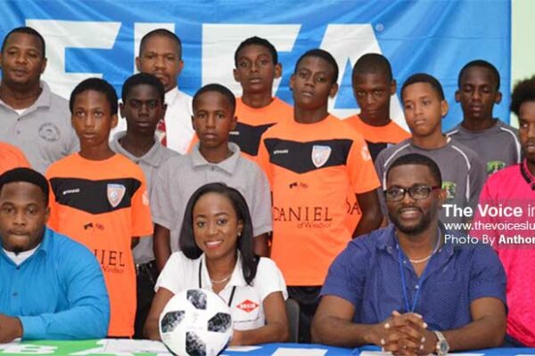 Image: (Front Row) A photo moment for GIFL President Shane Paul, Guardsman Saint Lucia Limited representative Pauline Francis,CAP D: GIFL Vice President Charde Desir; (Back Row) coaches, managers and players from the various teams. (PHOTo: Anthony De Beauville)