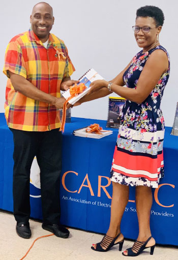 Image of Valerie Leon, Chairperson of SLCTVET makes a presentation to CARILEC Executive Director Dr Cletus Bertin.