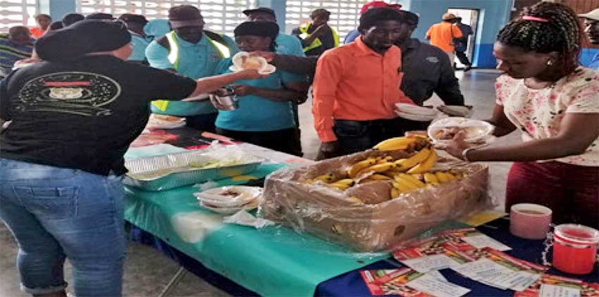 Image of employees of the Castries Constituency Council being treated to breakfast. 