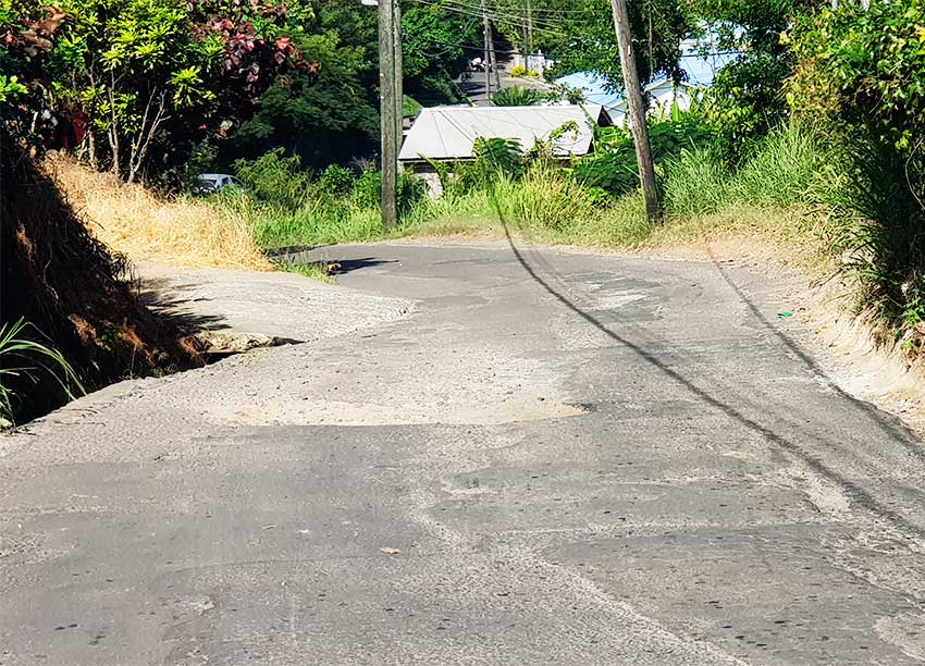 Image of a pothole that has devoured more than 80% of the road.