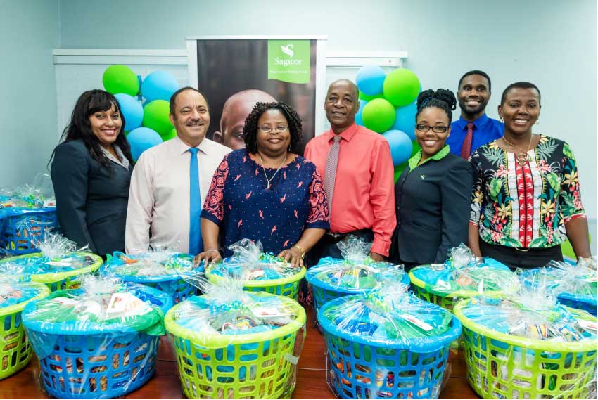 Image: Members of the Sagicor Team and Tanzia Toussaint of the Ministry of Equity, Social Justice, Local Government and Empowerment at the handover ceremony for Christmas hampers from Sagicor to the Ministry.