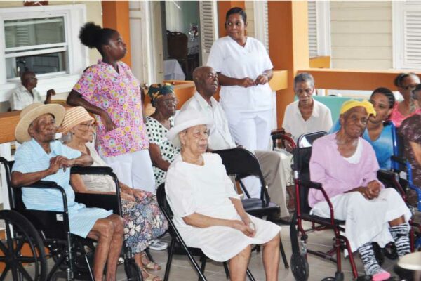 Image of residents with caregivers at the home.